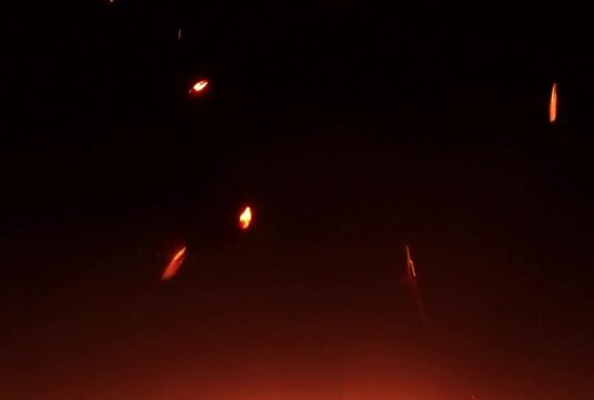 Fire and sparks embers particles over black bg, Fire is the rapid oxidation of a material
Bright glowing fire particles rising fast in a fiery sky with smoke. Fire flakes and bonfire background.