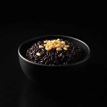 Thick heukmi juk (black rice porridge) with scattered pine nuts and light honey drizzle, deep black bowl, pure black background.