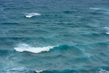 Fototapeta premium Ocean waves and water background. Deep blue sea surface view. Calm and powerful nature seascape with copy space. Tranquil horizon line.