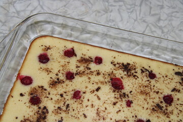 a pie in a mold on the table, a raspberry pie with chocolate crumbs,