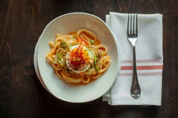 Fotobehang Eten Looking down on noodle dish with egg on top  © Cavan