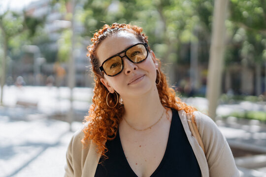 Portrait of a redhead woman in glasses