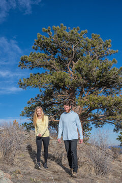 Couple hiking on sunny mountain trail