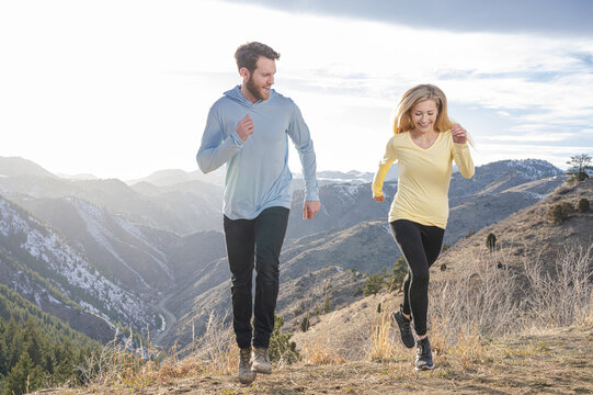 Couple running in the mountains