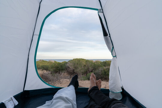 Relaxing inside tent enjoying ocean view camping