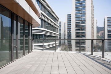Modern architectural complex viewed from rooftop terrace overlooking urban high-rise buildings © zhu difeng