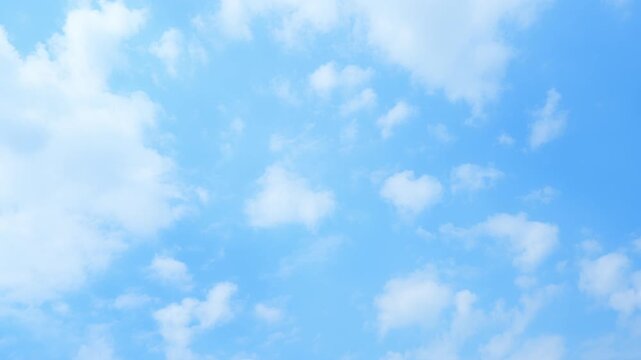 Blue sky timelapse video featuring drifting stratocumulus and soft cumulus clouds, showcasing evolving cloud formations, gentle atmospheric motion, and bright daytime weather patterns.
