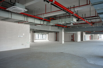 Empty office building interior with exposed structural elements and unfinished construction