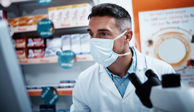 Computer, research and face mask with man in pharmacy for medical study, formulation and review. Healthcare investigation, drug development and microscope with mature person or pharmacist for science
