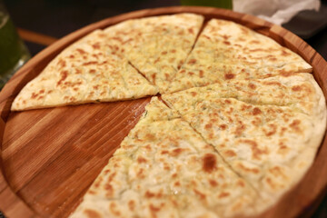 Hot appetizer made of baked dough with cheese for cafe