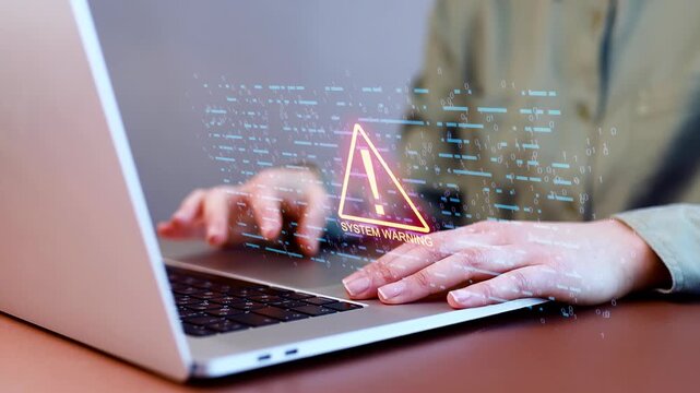 User receives a system warning on a laptop during troubleshooting at a workspace in the afternoon.