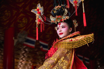 Portrait  Chinese regal empress in elegant embroidered costume and headdress in Chinese shrine