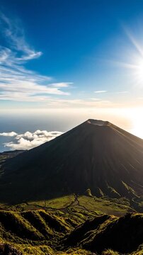 Majestic conical mountain peak with a visible crater overlooking the vast ocean