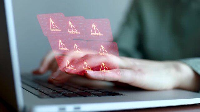 Person using a laptop showing multiple system warning alerts on the screen, indicating potential technological issues.
