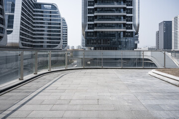 Modern urban sky bridge connecting curved glass facade high-rise buildings in a clean cityscape © zhu difeng
