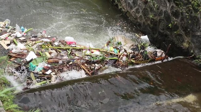 River debris. Piles of rubbish block the flow of river water.