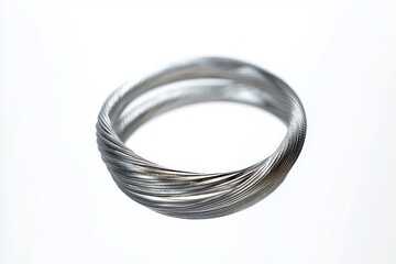 Fototapeta premium Coiled multi-strand silver wire bracelet made of twisted metal strands, sleek minimalist design conveying calm elegance