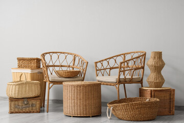 Interior of stylish living room with rattan armchairs, coffee table and different wicker baskets