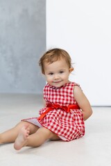 European one year baby model with curly hair and green eyes with happy face, beatiful smiling, first teeth celebrating christmas, birthday or happy easter