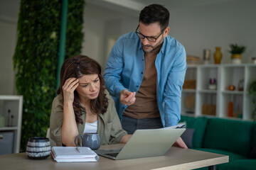 Fototapeta premium Couple experiencing financial stress and conflict at home