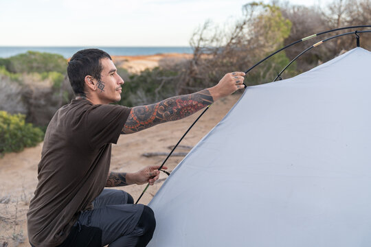 Man setting up camping tent for outdoor adventure