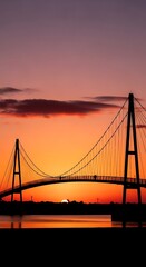 Fototapeta premium Silhouette of suspension bridge at sunset.