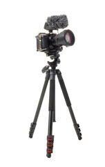 Modern photo camera with windscreen on tripod against white background