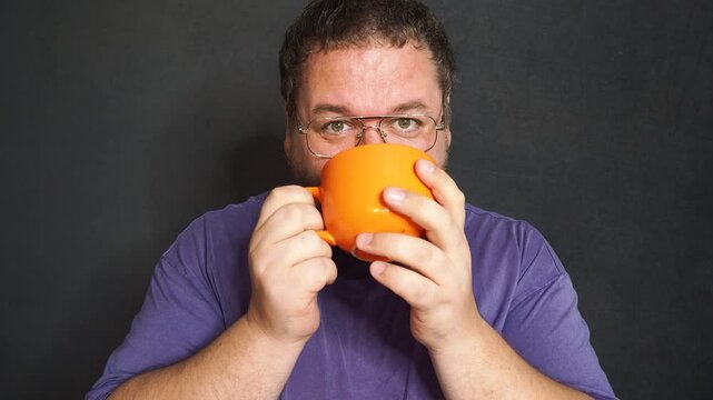 Funny fat man drinking hot coffee