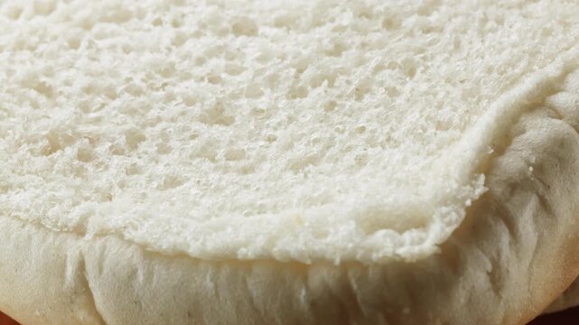 Teacake bread bun roll extreme macro close up with a rotating camera motion stock footage