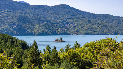 Chapel Saint-Michel standing on island in lake Lac de Serre-Poncon, Alpes-de-Haute-Provence, France, Europe.