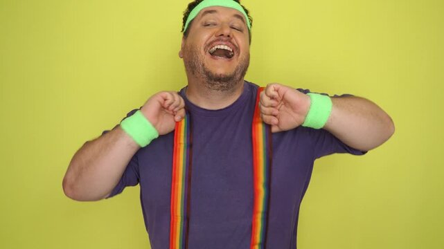 A funny fat man with a gay flag enjoys life.