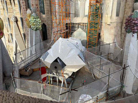 BARCELONA, SPAIN - NOVEMBER 2025: A massive component of the main Cross for the Tower of Jesus Christ sits on a terrace during construction of the Sagrada Familia basilica.