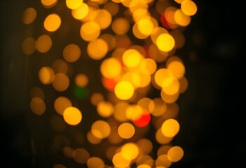 Obraz premium A vibrant display of glowing lights creates a mesmerizing bokeh effect against a dark background at night.