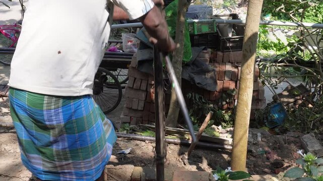 Manual borewell drilling process in progress