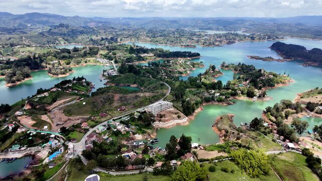Breathtaking Panoramic View, Panning Across the Massive El Pe&ntilde;ol Rock Summit, Showcasing the Guatape Reservoir Islands and Lush Colombian Andean Mountain Range.