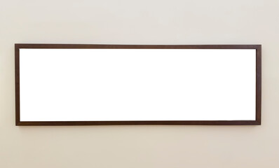 Panoramic horizontal picture frame hangs on beige wall in modern interior. Wooden long rectangle