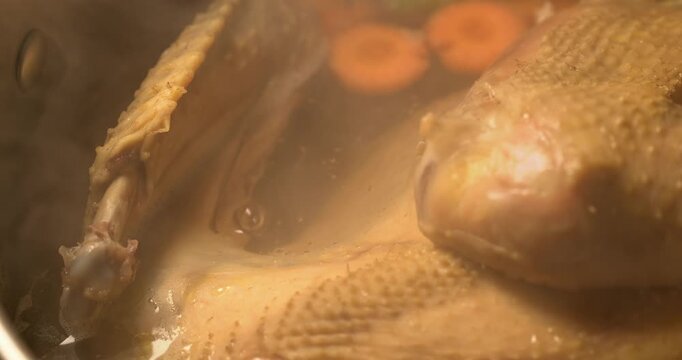 Organic chicken broth is boiling. Homemade chicken broth. Chicken soup.