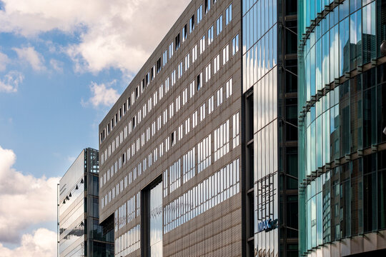 Corporate urban office facade in glass and steel during daylight featuring skyline architecture with repeating pattern geometry and clean lines