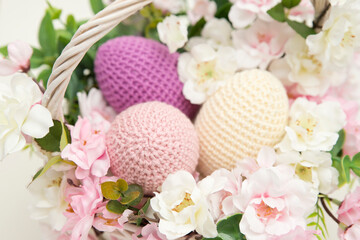 Spring equinox celebration. Easter theme composition with flowers and crocheted eggs. Featuring bouquets with handmade accents.
