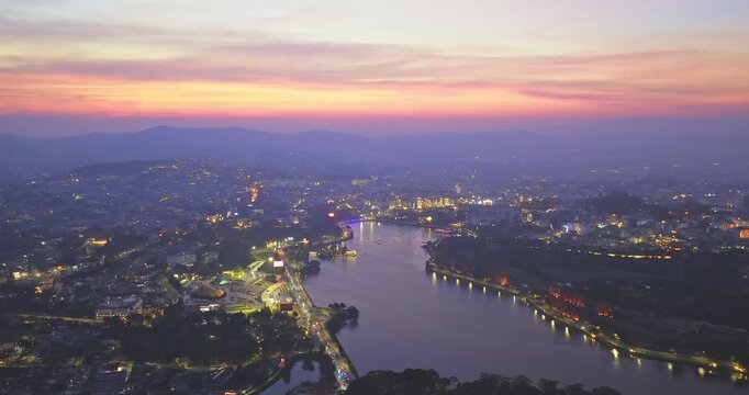 Aerial view of Da Lat city, Vietnam at sunset and night. Tourist city in developed Vietnam. Center Square of Da Lat city with Xuan Huong lake.