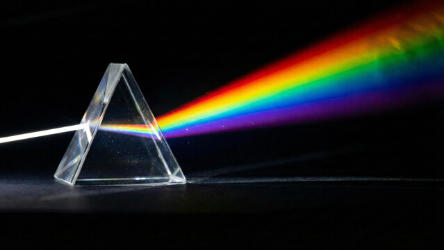 Crystal prism refracting light into rainbow spectrum
