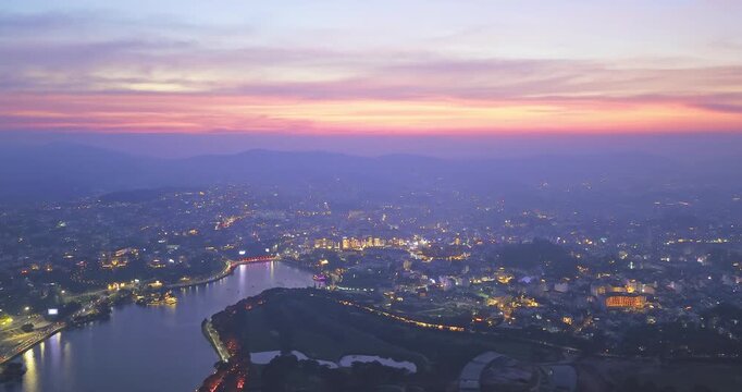 Aerial view of Da Lat city, Vietnam at sunset and night. Tourist city in developed Vietnam. Center Square of Da Lat city with Xuan Huong lake.