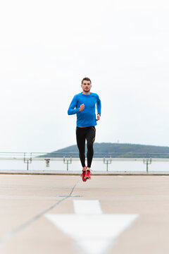 Young man running on parking level