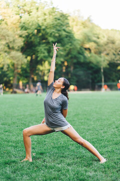 Young woman doing yoga exercise in a park