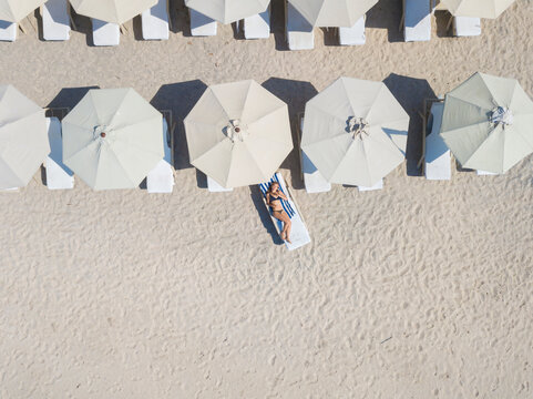 Woman lying on sun lounger at the beach, Gili Air, Gili Islands, Indonesia