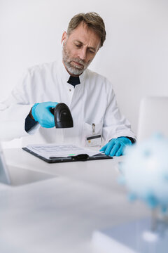 Scientist scanning forms at desk