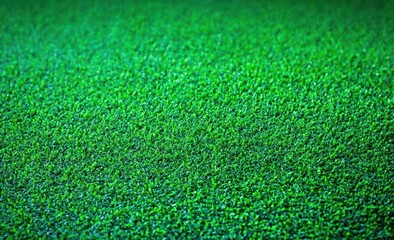 Fototapeta premium close-up of dense vibrant green grass blades forming a uniform lawn with a fresh, calming feel