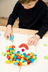 Paper plate clown. DIY games at home, activities for pre-school Kids. 5 minute crafts. Children joy and funny to cut a hair for clown. Red Nose Day theme.