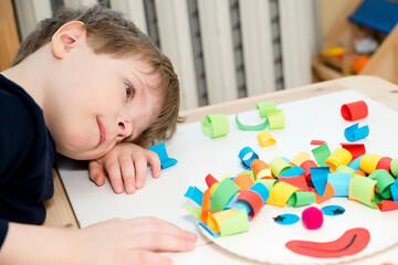 Paper plate clown. DIY games at home, activities for pre-school Kids. 5 minute crafts. Children joy and funny to cut a hair for clown. Red Nose Day theme.