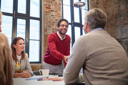 Colleagues greeting ata presentation in the office at a business meeting